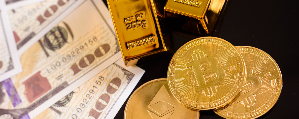 Close up of gold bullion, $100 bills and physical bitcoin and etherium